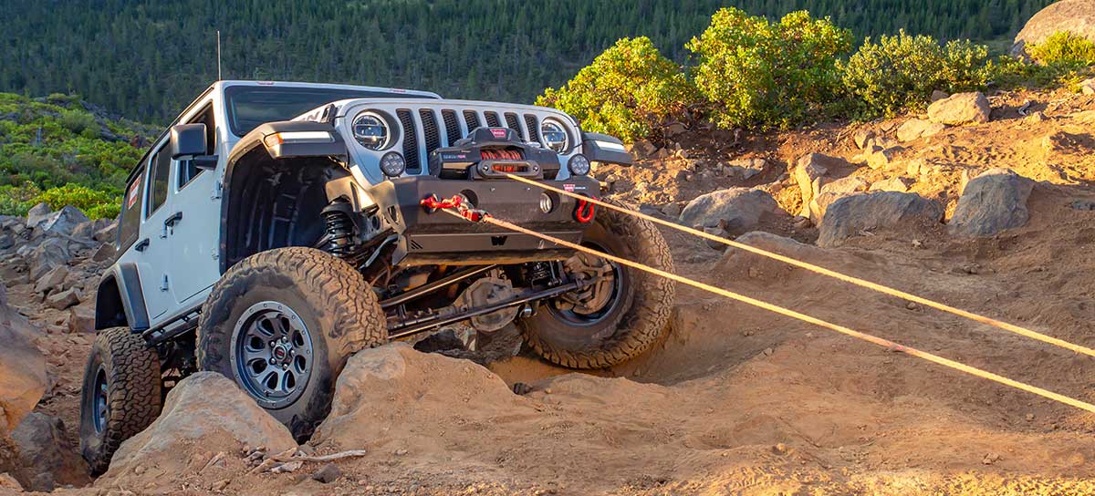 jeep winching up sandy rocks, using double line pull technique